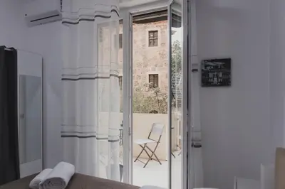 a room with a sliding glass door with a chair outside at Mariblu Palermo in Palermo