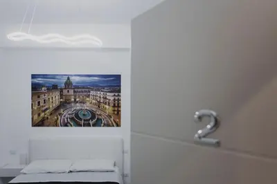 a picture of a building on the wall in a room at Mariblu Palermo in Palermo