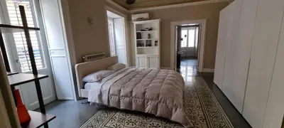 a hallway leading to a kitchen with a refrigerator at La casa di Alice Palermo Casa Professa in Palermo