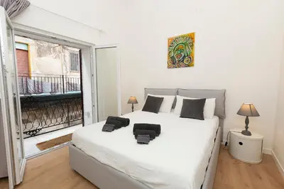 a bedroom with a large bed and a window at Massim'home in Palermo