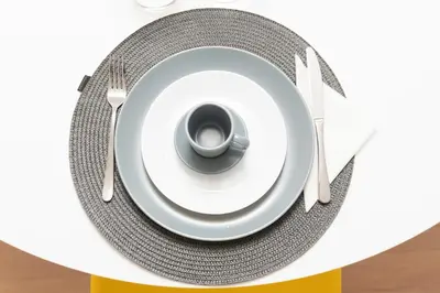 a plate with a cup and a fork and knife at Massim'home in Palermo