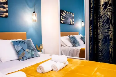 a bedroom with two beds and a mirror at Oasi Libertà in Palermo
