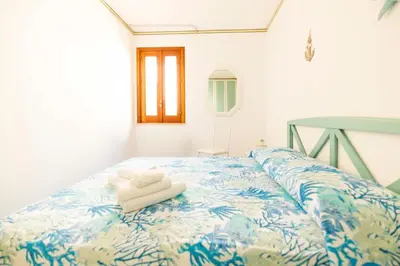 a bedroom with a bed with towels on it at Calasole House: Mare a 2 Passi in San Vito lo Capo