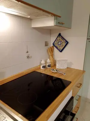 a kitchen with a wooden counter top and a counter top at Calasole House: Mare a 2 Passi in San Vito lo Capo