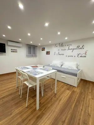 a dining room with a table and a bed at M&F Home in Palermo
