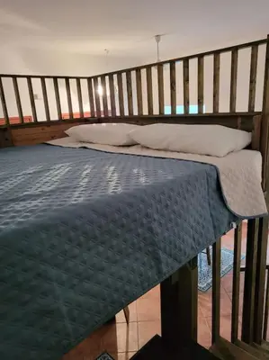 a bedroom with a bed with a wooden frame at Casa Vacanze Sole in Castellammare del Golfo