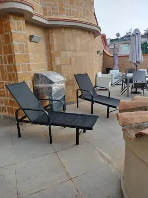 a group of black chairs sitting on a patio at La Casa di Anna, Mondello in Palermo
