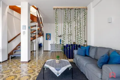 a living room with a couch and a table at Matasca casa vancanze in Palermo