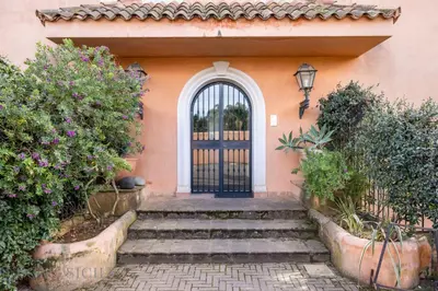 a door to a house with stairs and flowers at Casa Mediterranea Attitudine By DomuSicily in Mondello