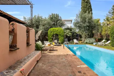 a swimming pool in a yard with a house at Casa Mediterranea Attitudine By DomuSicily in Mondello