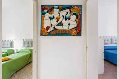 a room with a painting on the wall at Buffa Apartaments by DomuSicily in Mondello