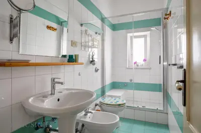 a bathroom with a sink and a toilet at Buffa Apartaments by DomuSicily in Mondello