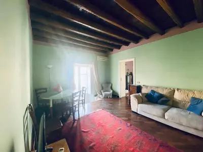 a living room with a couch and a table at casetta mon amour in Palermo