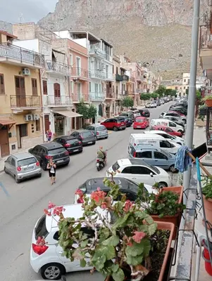 a view of a street with cars parked on the road at Casa giambona in Capaci