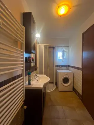 a bathroom with a sink and a washing machine at Casa giambona in Capaci