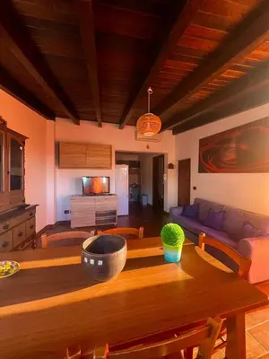 a living room with a wooden table and a couch at Casa giambona in Capaci