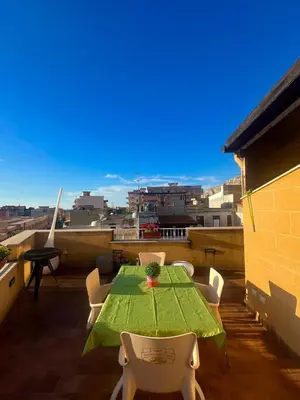 a green table and chairs on a balcony with a view at Casa giambona in Capaci