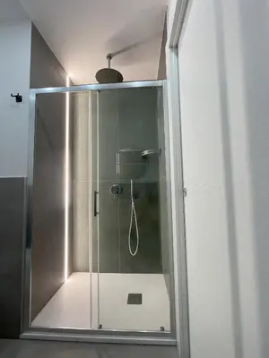a shower with a glass door in a bathroom at Central Empire in Palermo