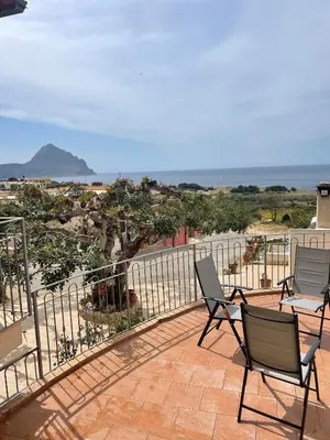 a patio with chairs and a view of the ocean at A Casa di Amy 2.0 in Macari