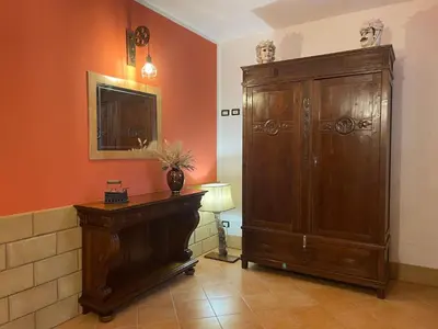 a room with a large wooden cabinet and a mirror at A Casa di Amy 2.0 in Macari