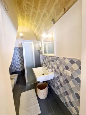 a bathroom with a sink and a toilet at Azzurra Home in Terrasini