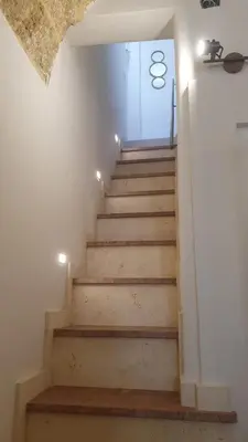 a stairway with wooden steps in a room at Azzurra Home in Terrasini