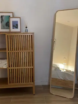 a mirror in a room next to a bedroom at Aloha in Palermo