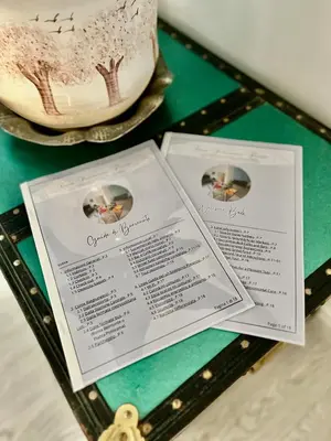a table topped with a wedding cake and menus at Casa Politeama Florio - Palermo centro in Palermo