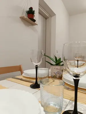 a table with two wine glasses on top of it at La Casetta di Nino in Castellammare del Golfo