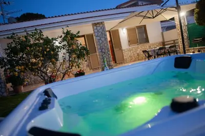 a bath tub with green water in front of a house at Villa Laura in Balestrate