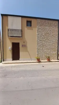 a building with a door and a balcony on it at Alykè Appartamenti Vacanze Macari in Macari