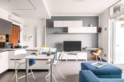 a kitchen and living room with a blue couch at FronteMare in Palermo
