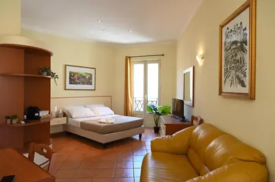 a living room with a couch and a bed at Politeama Theater Apartments in Palermo