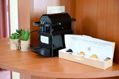 a coffee machine sitting on a table next to a box at Politeama Theater Apartments in Palermo