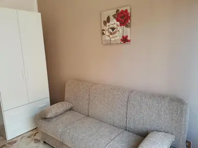 a living room with a couch and a picture on the wall at La Vie Est Belle in Balestrate