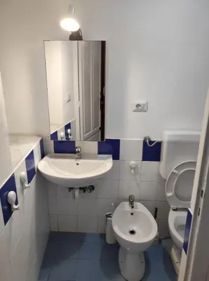 a bathroom with a sink and a toilet and a mirror at Casa Giannina in Palermo
