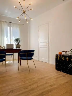a dining room with a table and chairs and a laptop at Castellano suites in Castellammare del Golfo