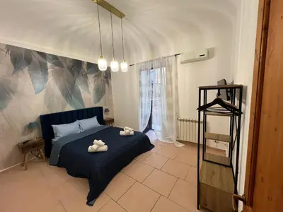 a bedroom with a bed with two towels on it at GRETA'S APARTMENT DISCESA DELLE CAPRE in Palermo