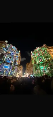 a large building with lights on it at night at GRETA'S APARTMENT DISCESA DELLE CAPRE in Palermo