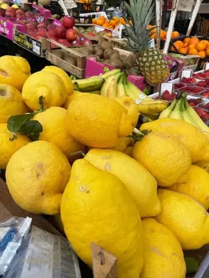 a pile of lemons and other fruits in a market at Studio 29 in Palermo