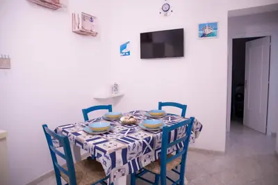 a dining room table with a blue and white table cloth at L'ancora casa vacanze in Palermo
