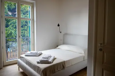 a white bedroom with a bed with towels on it at studio 338 in Palermo