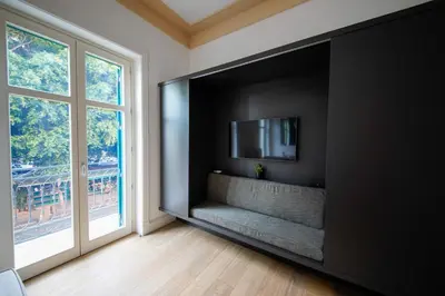 a living room with a flat screen tv on a wall at studio 338 in Palermo