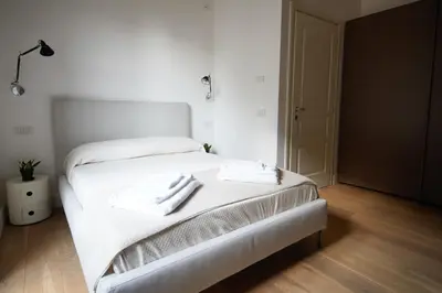 a bedroom with a white bed with two towels on it at studio 338 in Palermo