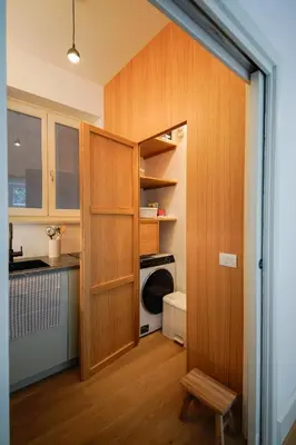 a kitchen with wooden cabinets and a washer and dryer at studio 338 in Palermo