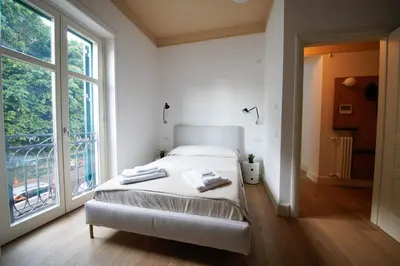 a bedroom with a bed and a large window at studio 338 in Palermo