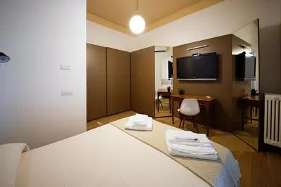 a room with a bed and a desk and a tv at studio 338 in Palermo