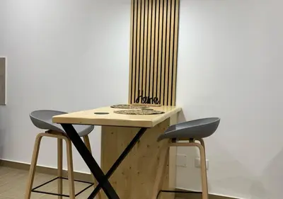 a wooden table with two stools in a room at Zisa Private House in Palermo