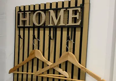 a sign that says home with hangers on a wall at Zisa Private House in Palermo