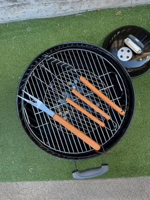 a grill with four hot dogs and a pair of scissors at Zisa Private House in Palermo